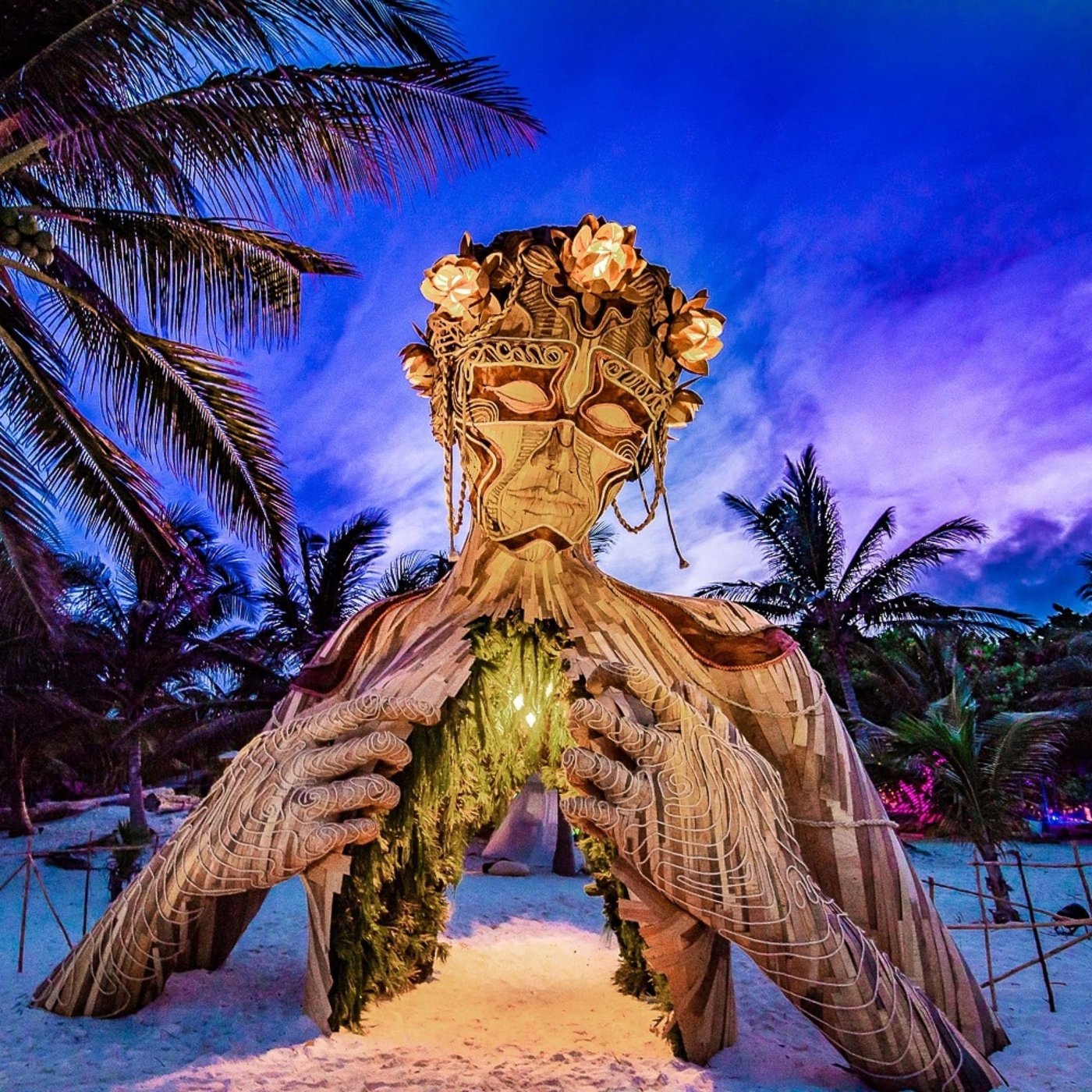 Giant wooden sculpture on the beach in Tulum at dusk