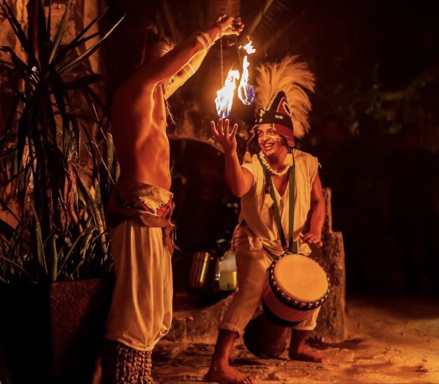 Fire performer and drummer with flaming poi